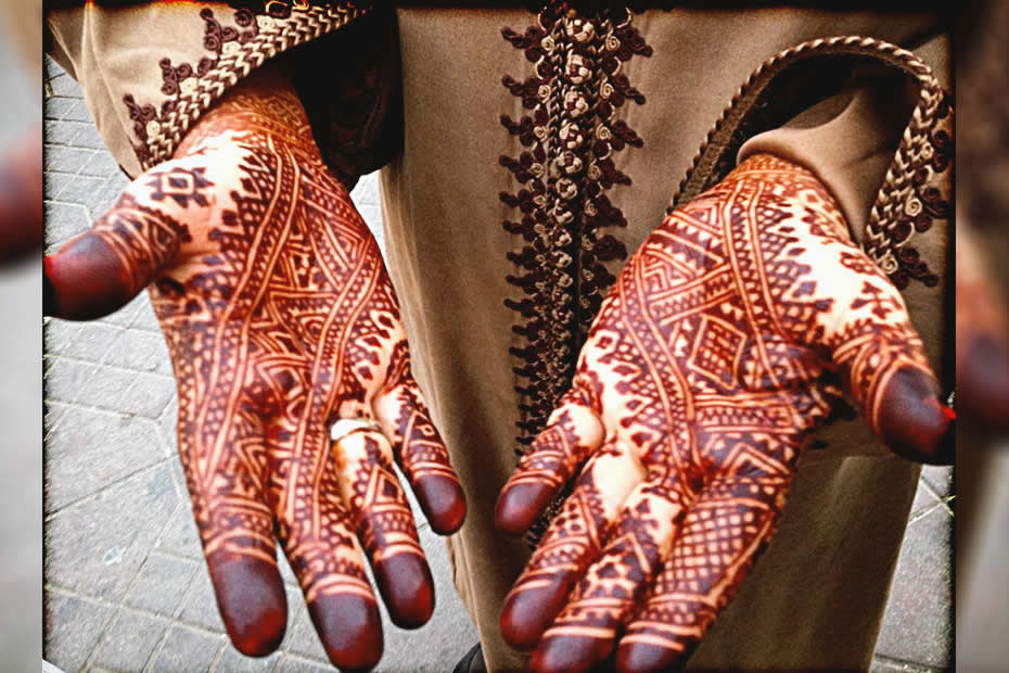 Moroccan henna tattoos on both of a ladies hand