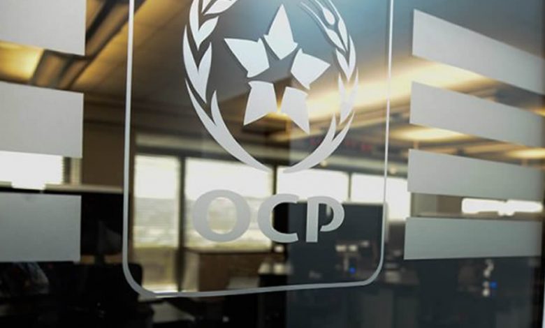 A glass wall with the OCP group's logo