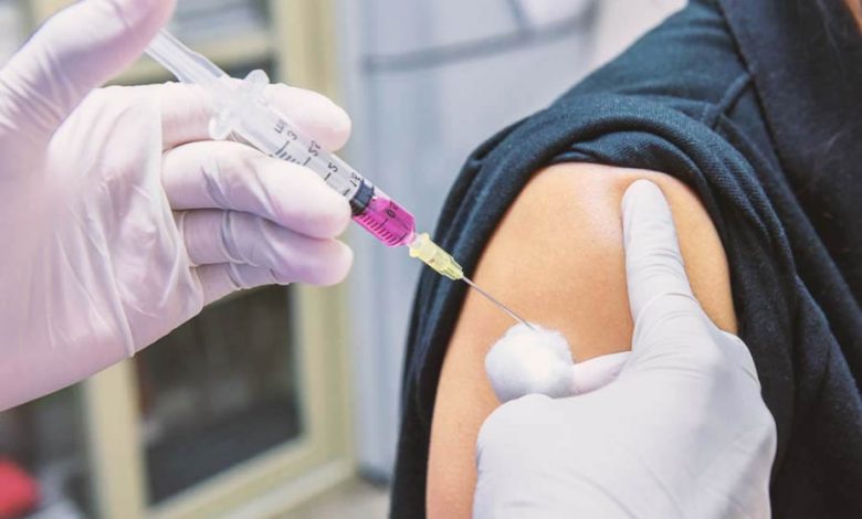 The shoulder of someone getting a vaccine shot