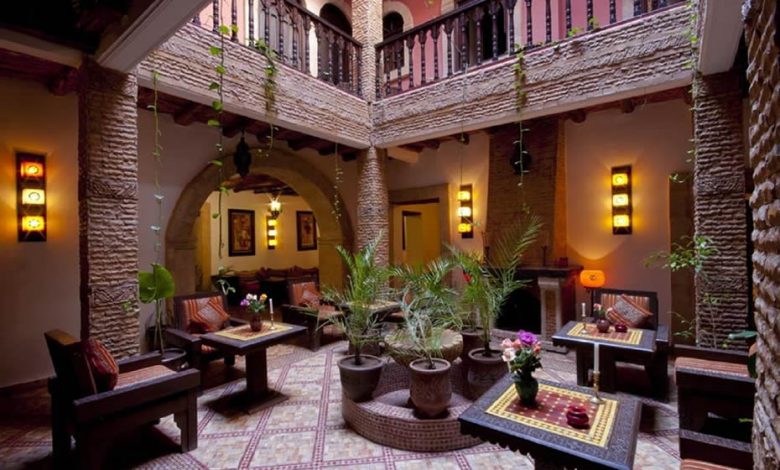A beautiful Moroccan riad with some Moroccan furnitures and ithems, and some decorative plants