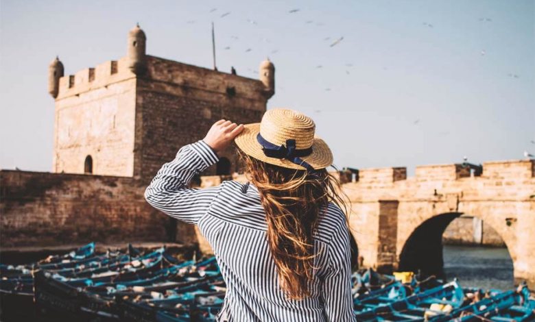 A picture of the back of a girl wearing a lined shirt and a hat in Essaouira, Morocco.