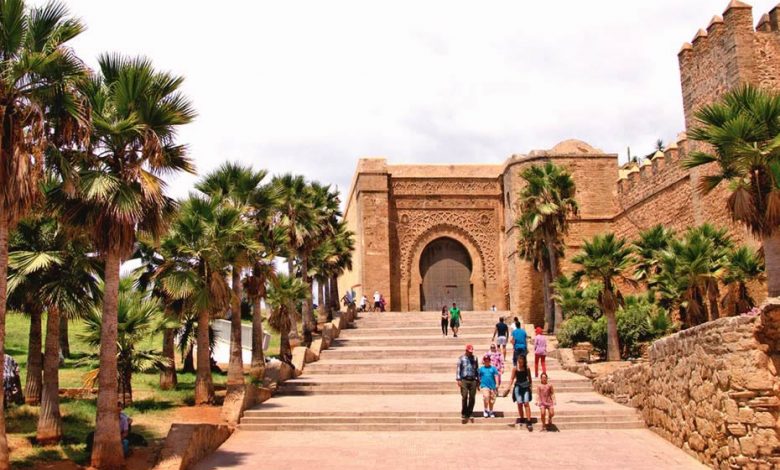 The Kasbah of the Udayas in Rabat, Morocco, with locals and tourits walking on the stairs.