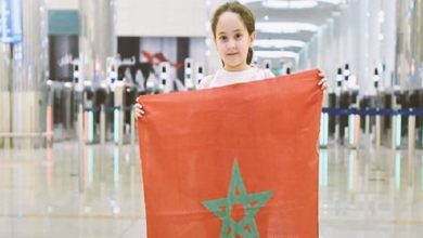 9-year-old Moroccan girl, Meriem Amjoune, winner of the Arab Reading Challenge 2018, holding the Moroccan flag.