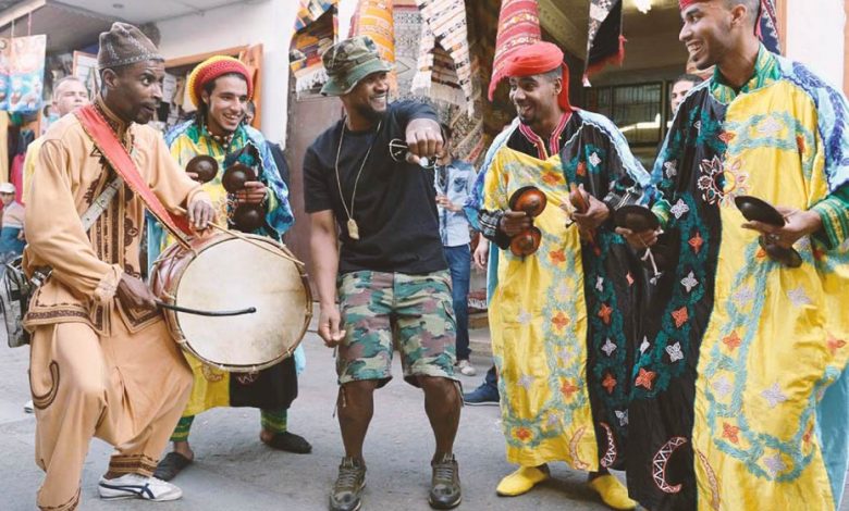 Usher dancing in Morocco with a gnawa group
