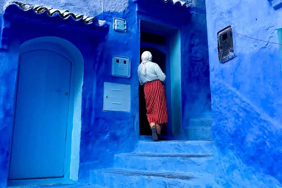 Why is the city of Chefchaouen in Morocco completely blue : a Moroccan woman wearing traditional Moroccan clothes of north of morocco