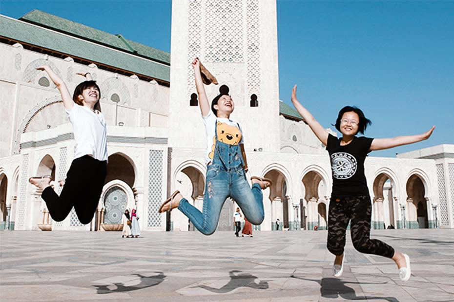  Casablanca place to visit: Tourists jumping in front of the Casablanca mosque Hassan II