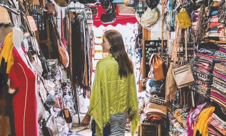 A Western woman wandering through a Moroccan souk in search of what to wear in Morocco.