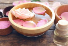 a bowl filled with pure natural homemade moroccan rose water and petal roses on top