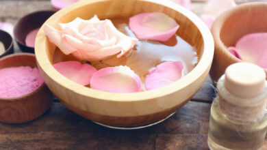 a bowl filled with pure natural homemade moroccan rose water and petal roses on top