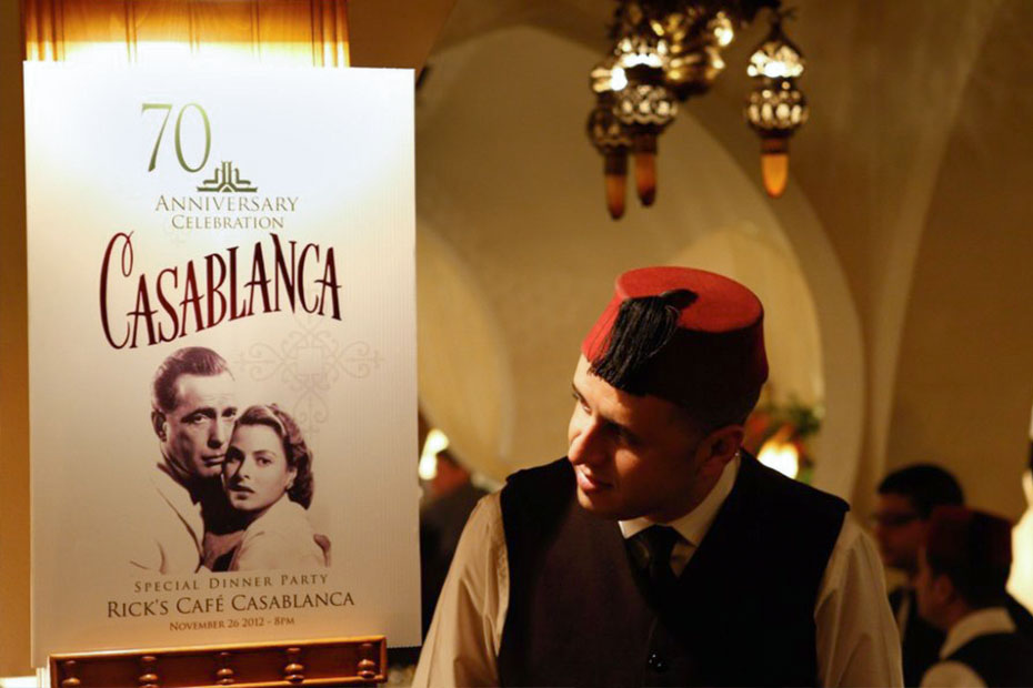 a waiter looking at the casablanca movie poster