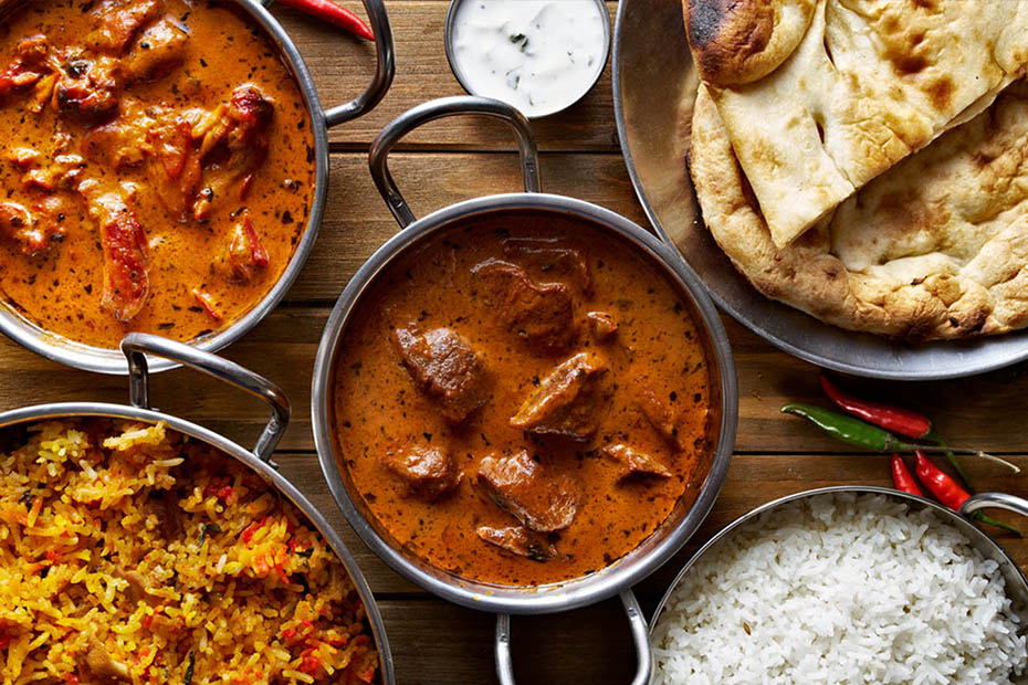 India best food spicy stews with curry and Indian bread on a wooden table